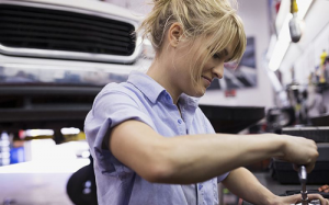 Fareham Car Garage - Lady fixing a car engine with blonde hair