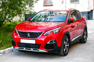 Fareham Car Garage - Bright red vehicle Peugeot SUV parked on a street